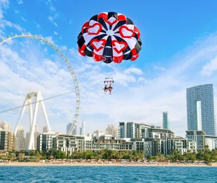 Laughing and flying together on a parasailing adventure in Dubai JBR